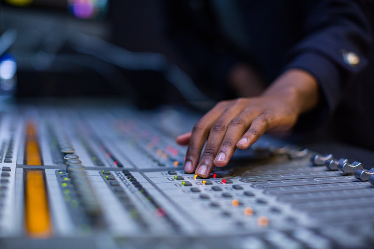 Close-up of Man Operating a Sound Console